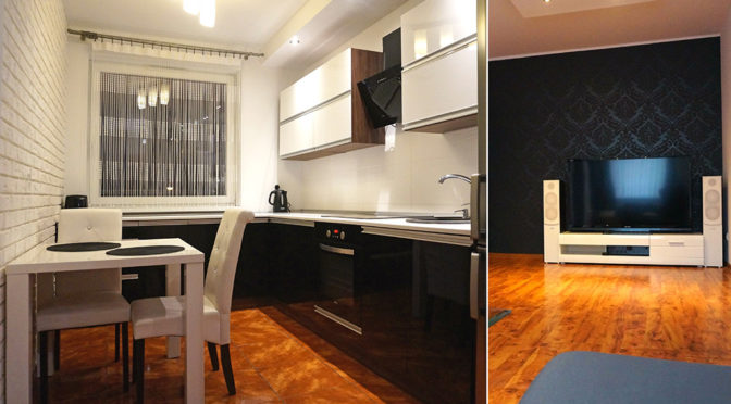 po lewej nowoczesna kuchnia, po prawej fragment salonu w ekskluzywnym apartamencie na sprzedaż Wrocław